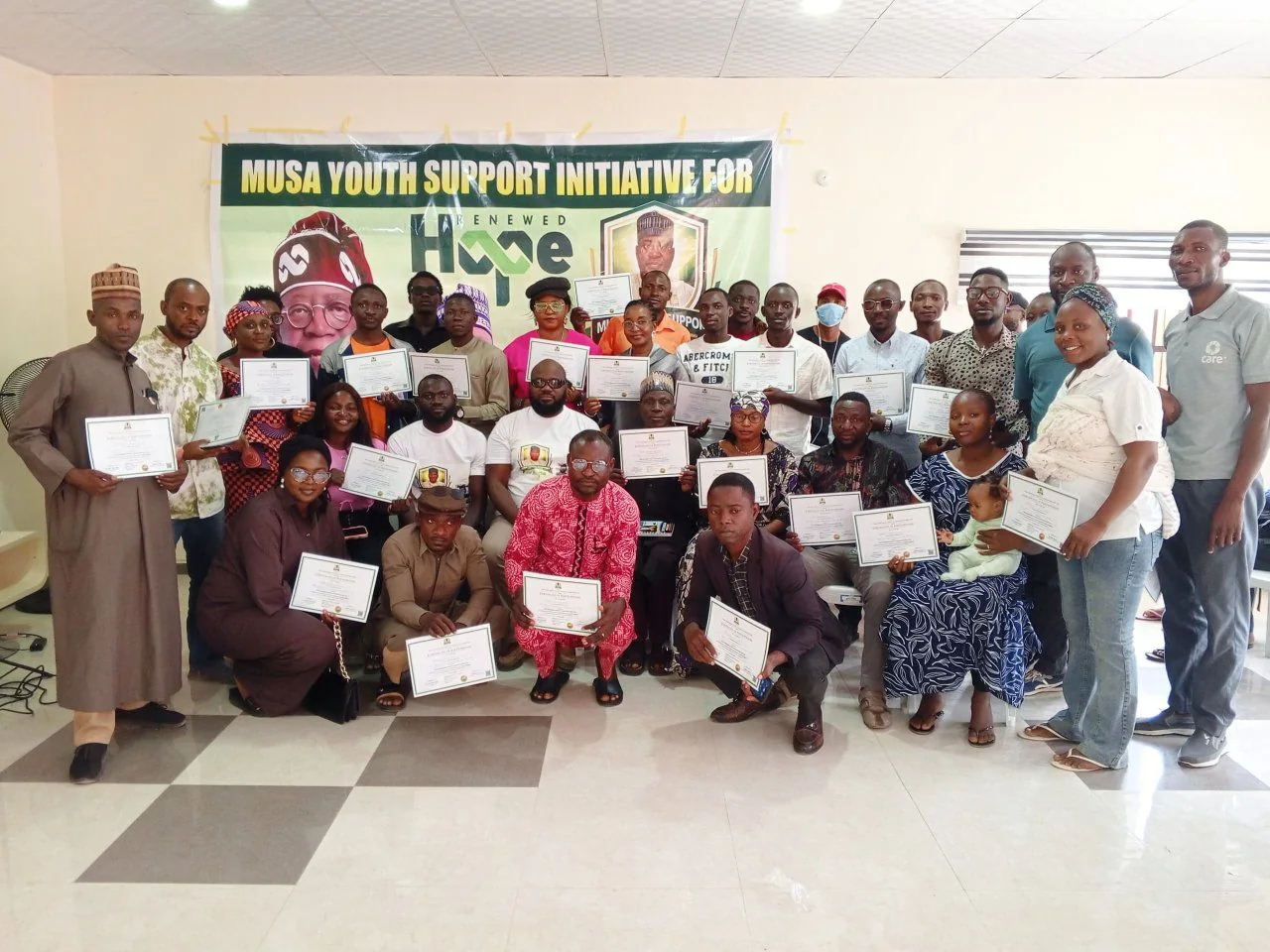 Programme participants posing together with completion certificates